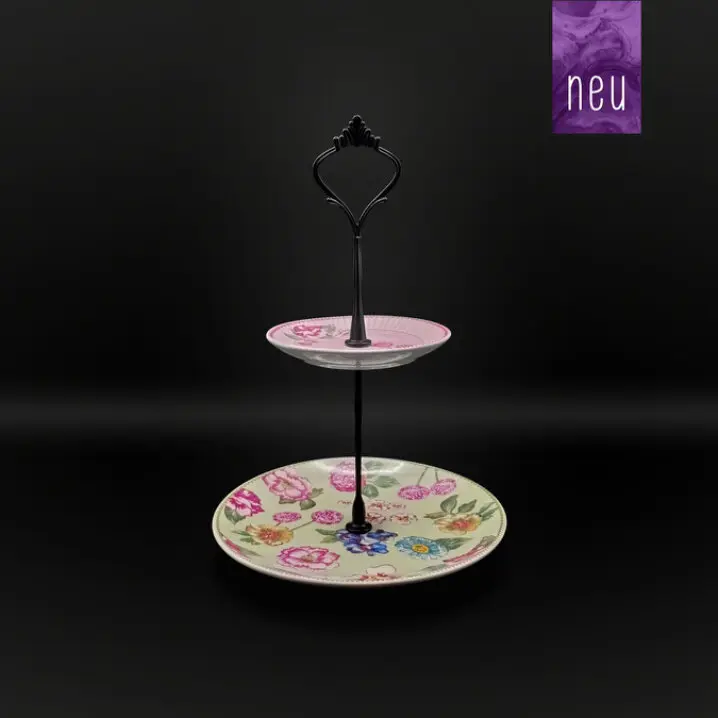 Zweistufige Etagere mit schwarzem Metallgriff, oben kleiner Teller mit rosa Muster, unten großer Teller mit buntem Blumenmotiv, vor schwarzem Hintergrund; oben rechts „neu“-Label.